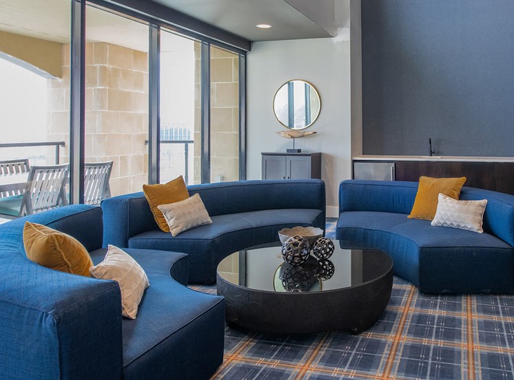 semi-circular couches around a circular coffee table indoors
